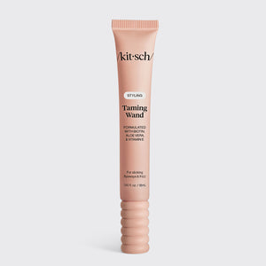KITSCH Styling Taming Wand — hero product shot of the pink tube standing alone on a light gray background — enriched with nourishing biotin, aloe vera, and vitamin E for added hydration — compact packaging makes it easy to style on the go