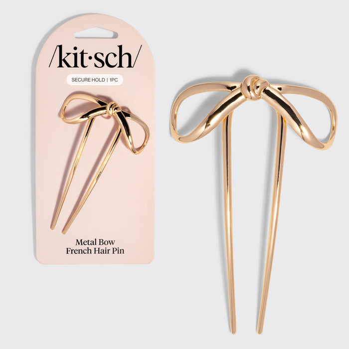 Gold metal bow French hair pin with packaging displaying 'kitsch' brand on a light gray background.