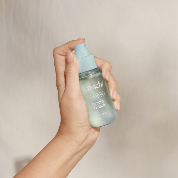 Hand holding Kitsch Beachy Gelato Hair Perfume spray bottle – 1.7 fl oz travel-friendly hair fragrance