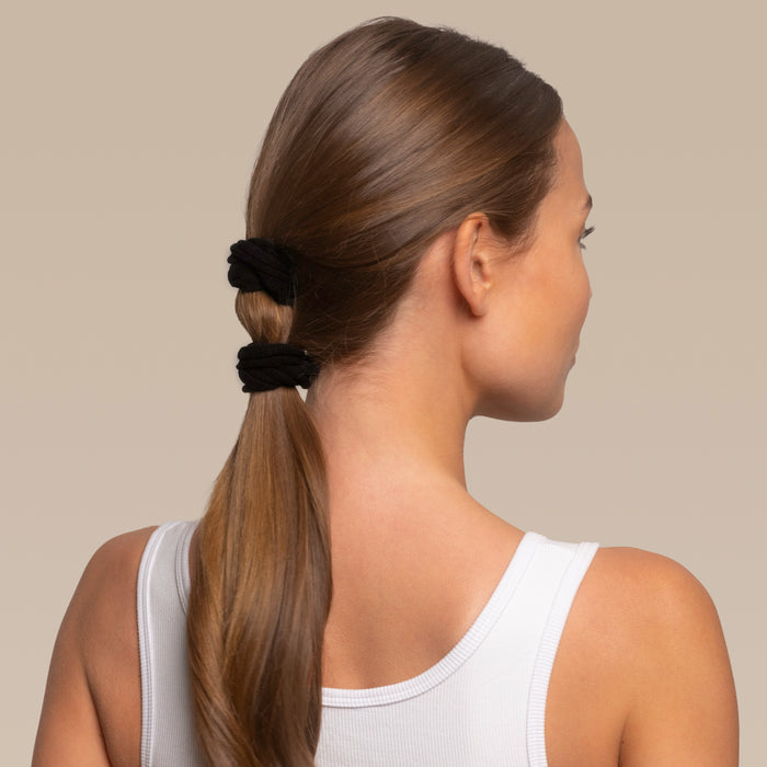 Person with a bubble ponytail using 2 kitsch black petal elastics