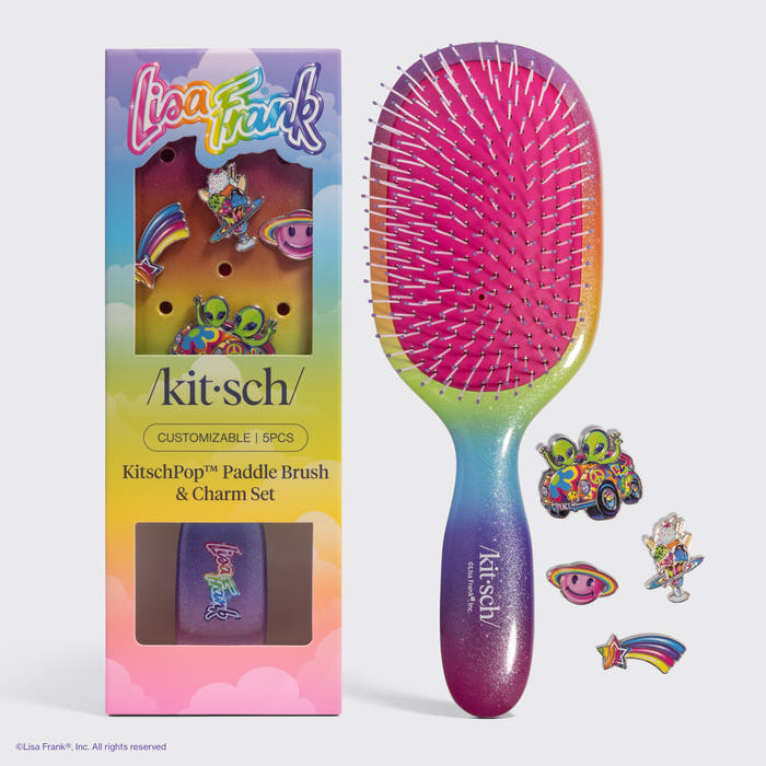 KITSCH Lisa Frank x KitschPop Paddle Brush 5pc Set - Fantastic World of Lisa Frank — rainbow ombre glitter paddle brush with pink bristles beside its box and four charms: alien car, smiley planet, astronaut, and shooting star — soft, flexible bristles, detangling quick and easy — can be used on wet or dry hair
