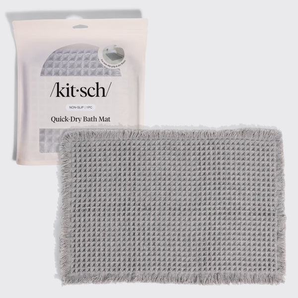 KITSCH Gray Quick-Dry Bath Mat — hero shot of the folded waffle-knit mat with its retail packaging — Plush waffle texture creates a soft, cushioned feel underfoot — an everyday luxury for your bathroom floor
