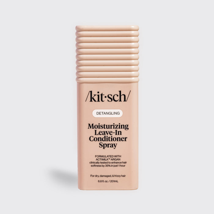 Kitsch Moisturizing Leave-In Conditioner Spray in blush packaging for dry, damaged, and frizzy hair, formulated with Actimilk™ Argan.