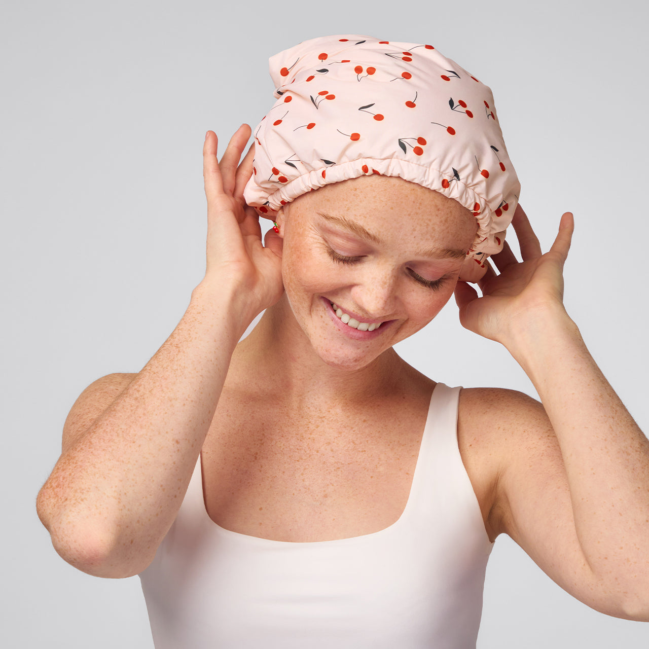 KITSCH Satin Lined Flexi Shower Cap — Cherry Print — worn on model, satin-lined interior visible