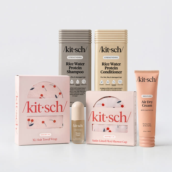 KITSCH Ultimate Shower Bundle — hero flat lay — Rice Water Protein Shampoo + Conditioner + Warm Sugar Hair Perfume + Air Dry Cream + Cherry Print Shower Cap + XL Hair Towel — complete shower upgrade