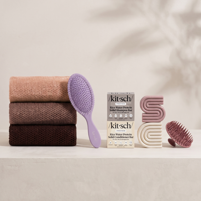 Kitsch Spring Welcome Kit Rice Water shown as a full bundle with the Strengthening Rice Water Shampoo and Conditioner Bars, Soft Violet Wet/Dry Brush, Terracotta Scalp Exfoliator and Rosewood African Net Sponge on a soft neutral background